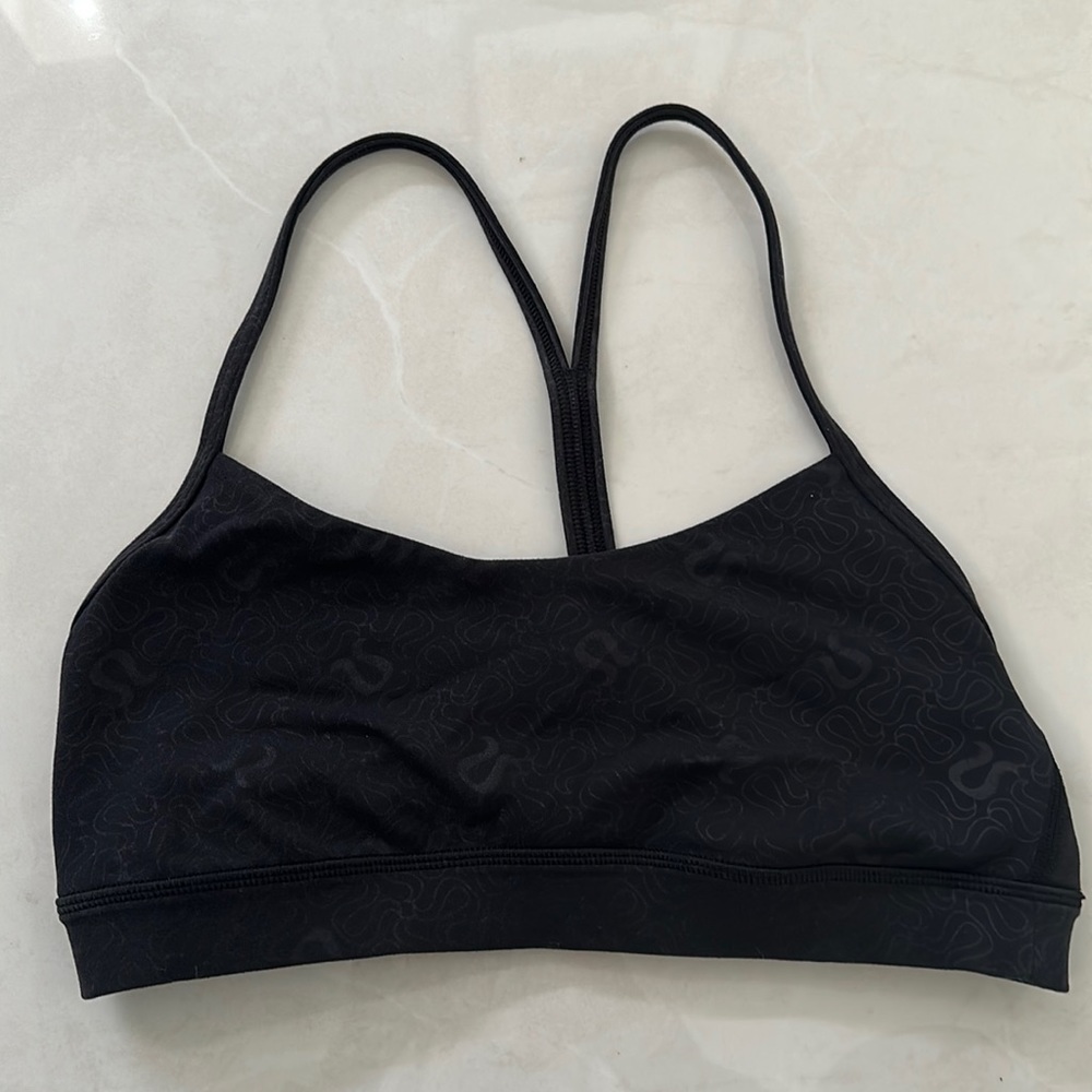Lululemon flow y nulu sports bra. Black with lululemon pattern.